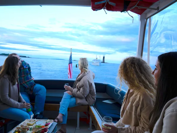 Women celebrating on a private Maine bachelorette boat charter